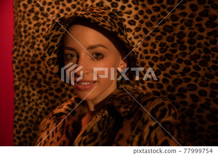Woman with piercing wearing leopard look looking at the camera Woman with piercing wearing leopard look looking at the camera 77999754