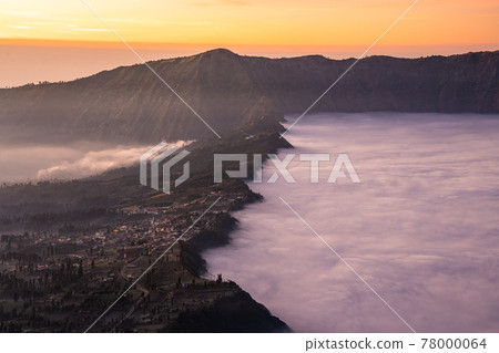 Beautiful sunrise with sea of fog at Cemoro Lawang village at mount Bromo volcano in, East Java, Indonesia.. 78000064