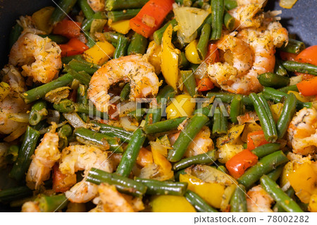 prawns fried with beans close-up. Onion and bell pepper 78002282