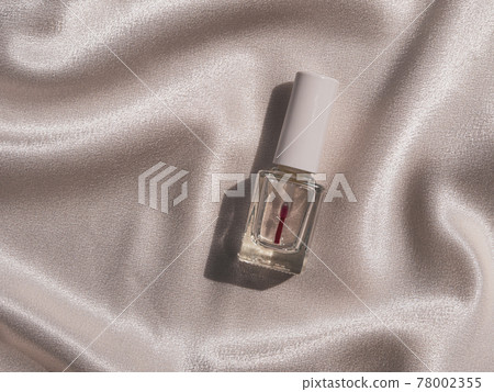 Nail polish bottle mockup with harsh shadow on white silk background french manicure cosmetics product. 78002355