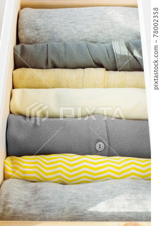 a stack of clothes in a drawer a stack of clothes in a drawer 78002358