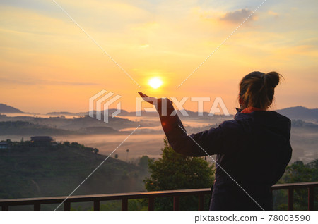 Asian woman enjoys the view of misty landscape in morning at Khao Kho hill in Phetchabun, Thailand Asian woman enjoys the view of misty landscape in morning at Khao Kho hill in Phetchabun, Thailand 78003590
