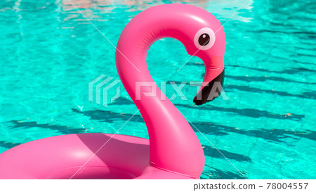Flamingo icon. Pink inflatable flamingo in pool water for summer beach background. Trendy summer concept. Flamingo icon. Pink inflatable flamingo in pool water for summer beach background. Trendy summer concept. 78004557