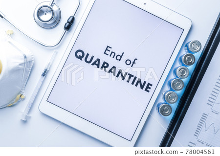 End of quarantine. Medical equipment: doctor stethoscope, hospital healthcare charts, syringe with needle and white tablet with text on screen. End of quarantine concept. End of quarantine. Medical equipment: doctor stethoscope, hospital healthcare charts, syringe with needle and white tablet with text on screen. End of quarantine concept. 78004561