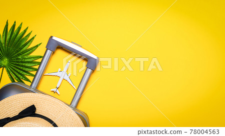 Beach background. Womens accessories traveler: suitcase, white plane, sunglasses on yellow background with empty space for text. Design of summer vacation holiday concept. Beach background. Womens accessories traveler: suitcase, white plane, sunglasses on yellow background with empty space for text. Design of summer vacation holiday concept. 78004563