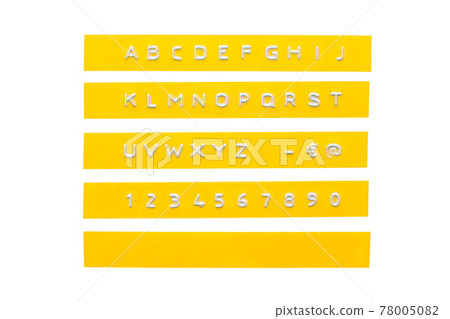 embossed alphabet on yellow plastic tape, isolated on white 78005082