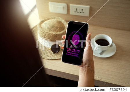 Woman on holiday using smartphone to sign a password by Fingertip. Mobile Security Concept. 78007894