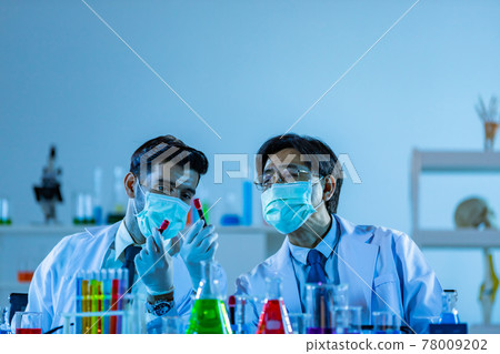 Team of research scientists analysing test trial new generation vaccine data. 78009202