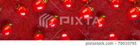 Cherry tomato pattern on a red tomato paste or Ketchup background. Flat lay, top view Cherry tomato pattern on a red tomato paste or Ketchup background. Flat lay, top view 78010795