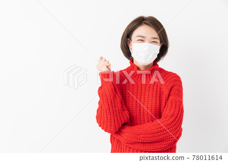 A woman with a mask smiles A woman with a mask smiles 78011614