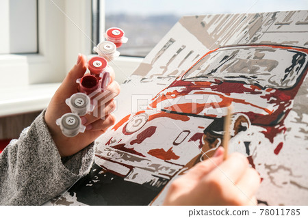 Female hands coloring canvas Picture by numbers car and girl. Creative hobby. Painting for beginners. Leisure activity for stay home isolation, anti-stress idea. Meditation, relax concept Female hands coloring canvas Picture by numbers car and girl. Creative hobby. Painting for beginners. Leisure activity for stay home isolation, anti-stress idea. Meditation, relax concept 78011785