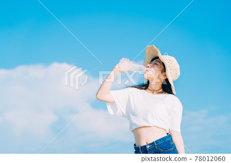 A girl drinking a drink 78012060