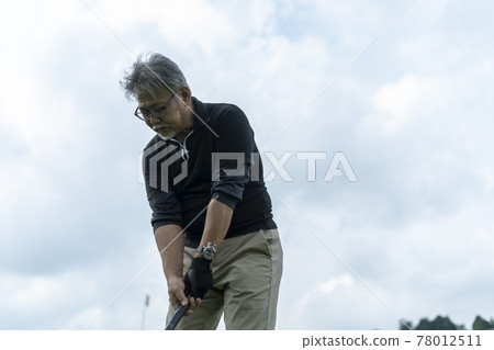 Senior man enjoying ground golf Senior man enjoying ground golf 78012511