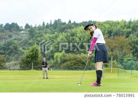 A woman enjoying golf A woman enjoying golf 78013991