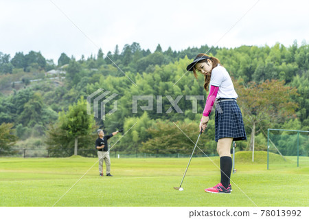 A woman enjoying golf A woman enjoying golf 78013992