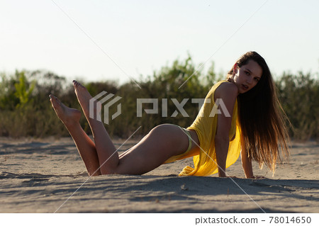 Sensual stylish young female traveler relaxing on beach Sensual stylish young female traveler relaxing on beach 78014650
