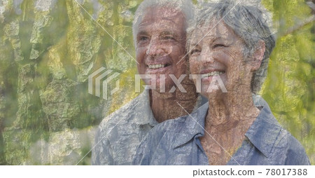 Composition of senior couple embracing, smiling and autumn foliage 78017388
