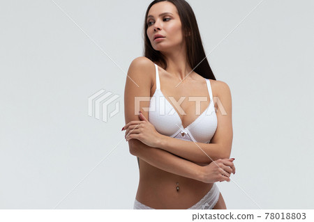 Slim woman in lingerie in studio 78018803