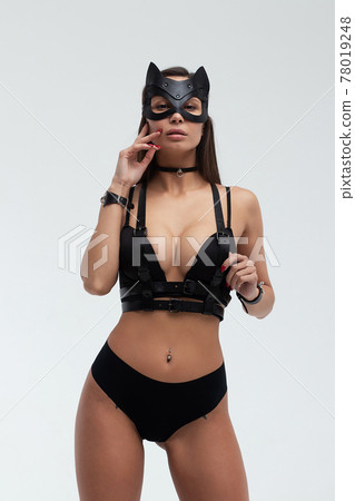 Sexy woman in black mask and lingerie in studio 78019248