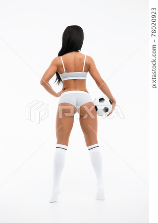 Slim content female football trainer in white underwear in studio Slim content female football trainer in white underwear in studio 78020923