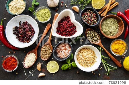 Various spices in a bowls on a black 78021996
