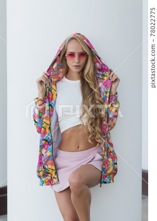 Trendy female leaning on railing Trendy female leaning on railing 78022775