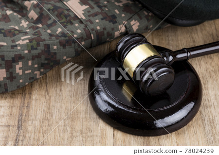 Crime and law - gavel placed in front of military uniforms Crime and law - gavel placed in front of military uniforms 78024239