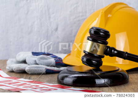 Crime and law - helmet, safety gloves and gavel 78024303