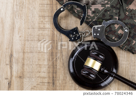 Crime and law - handcuffs and military uniforms, gavel 78024346