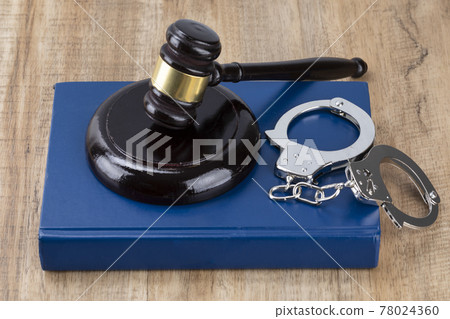 Crime and law - gavel placed on the cuffs and Code Crime and law - gavel placed on the cuffs and Code 78024360