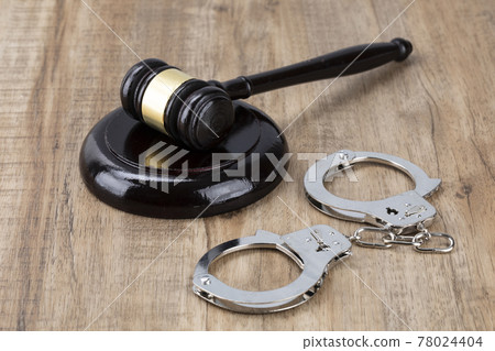 Crime and law - handcuffs and gavel Crime and law - handcuffs and gavel 78024404
