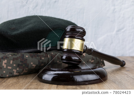 Crime and law - gavel placed in front of military uniforms Crime and law - gavel placed in front of military uniforms 78024423