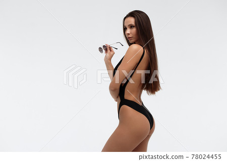 Sexy slim model in stylish black swimsuit Sexy slim model in stylish black swimsuit 78024455