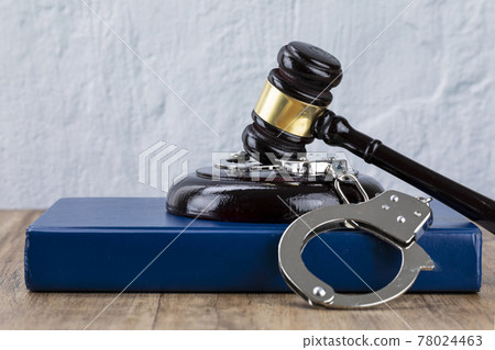 Crime and law - gavel placed on the cuffs and Code 78024463