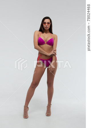 Attractive woman in red bikini and sunglasses 78024468