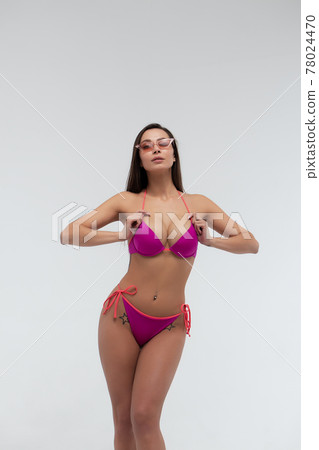 Attractive woman in red bikini and sunglasses 78024470
