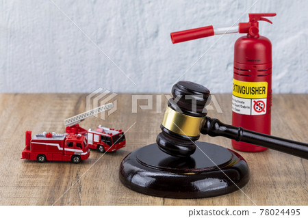 Crime and law - miniature fire car, fire extinguishers and gavel 78024495