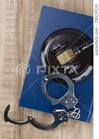 Crime and law - gavel placed on the cuffs and Code Crime and law - gavel placed on the cuffs and Code 78024518