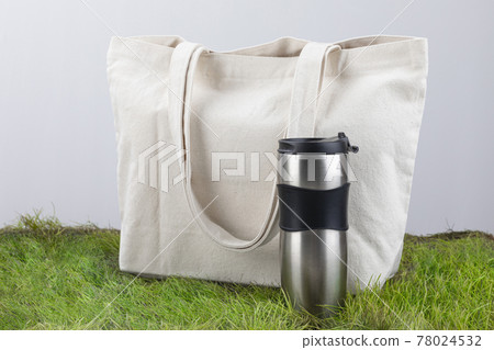 Zero Waste - eco bag and tumbler on grass Zero Waste - eco bag and tumbler on grass 78024532