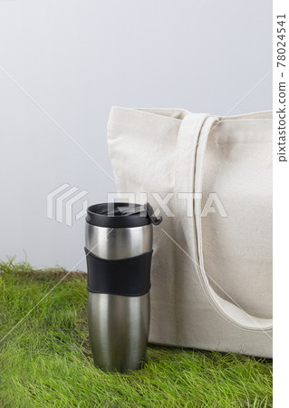 Zero Waste - eco bag and tumbler on grass 78024541