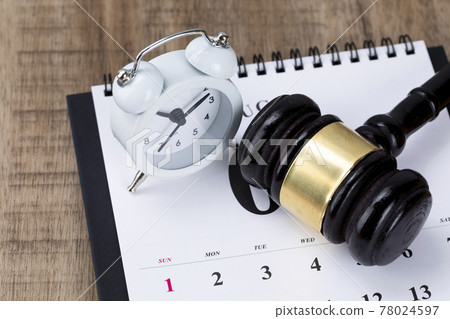 Crime and law-Desktop calendar and alarm clock and gavel 78024597