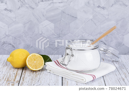 Zero waste cleaning - powdered citric acid, wood spoon and lemon 78024671