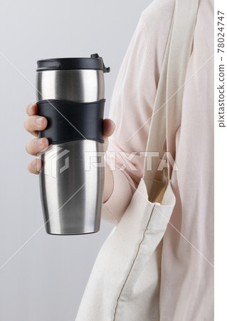Zero waste - person carrying eco bg and tumbler Zero waste - person carrying eco bg and tumbler 78024747