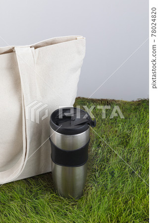 Zero Waste - eco bag and tumbler on grass Zero Waste - eco bag and tumbler on grass 78024820