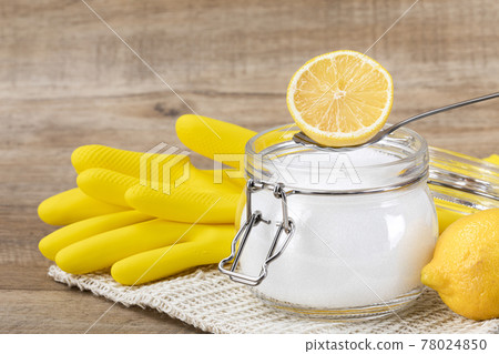 Zero waste cleaning - powdered citric acid, wood spoon and lemon 78024850
