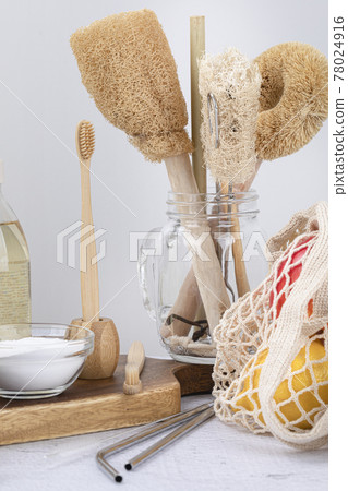 Zero waste products - baking soda, bamboo brush, net bag with fruits, stainless straw 78024916