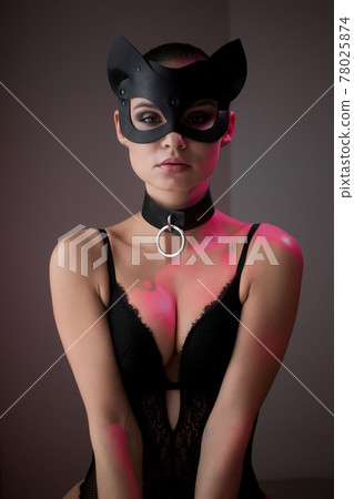 Brunette girl in a cat mask Brunette girl in a cat mask 78025874