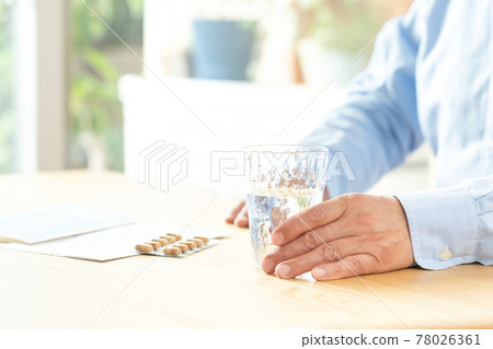 Middle-aged and older men taking medicine Middle-aged and older men taking medicine 78026361