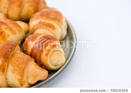 Homemade delicious croissants on a dessert gray plate. Tasty homemade croissants cake. Frances national food Homemade delicious croissants on a dessert gray plate. Tasty homemade croissants cake. Frances national food 78026369