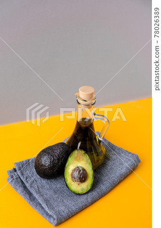 Pitcher of natural oil and fresh ripe hass avocados. Preparing food in the kitchen. Ingredients. Concept of healthy food. Minimalistic concept in isometric style in trendy colors. 78026389